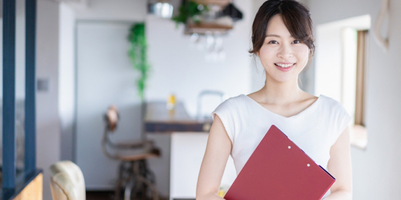 ファイルを持っている白い服の女性
