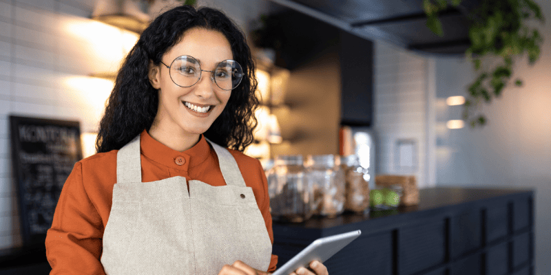 タブレットを持ってほほ笑む女性スタッフ